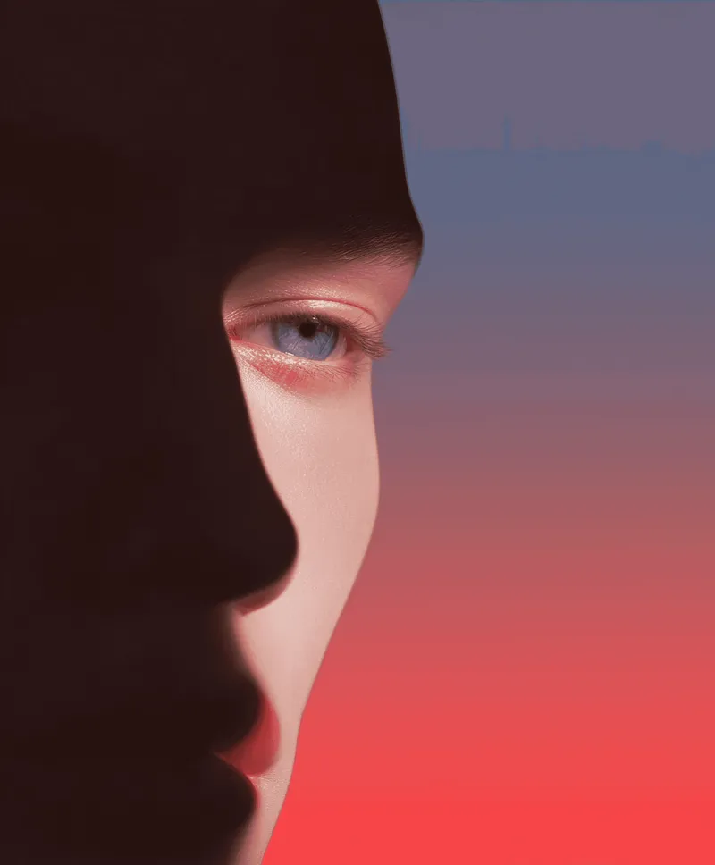 Half of a face in shadow under pink-red light